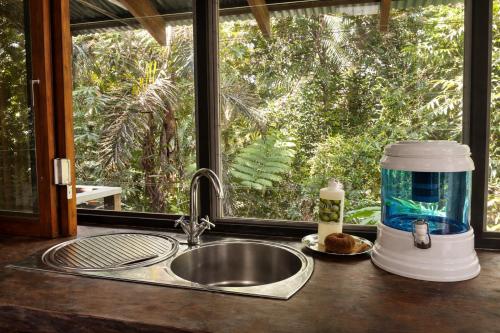 a kitchen counter with a sink and a window at Firefly in Diwan