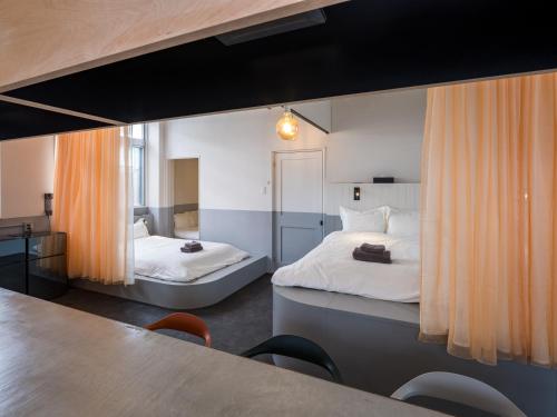 a bedroom with two beds and a table with chairs at SMIRE STAY Ishigaki in Ishigaki Island