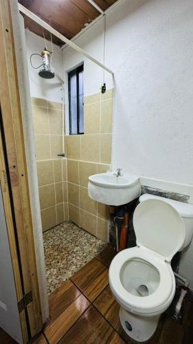 a bathroom with a toilet and a sink at Luminous Haven Atitlan #1 in San Marcos La Laguna