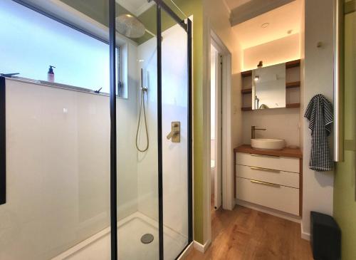 a bathroom with a shower and a sink at Queen's Landing in Nelson