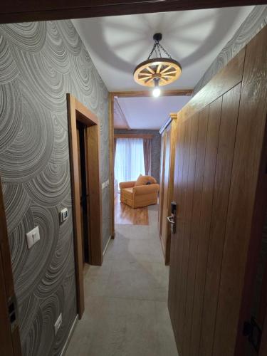 a hallway with a door and a couch in a room at Arija Luxury Suite in Kolašin