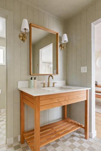 a bathroom with a sink and a mirror at The Herondale Hotel in Astoria, Oregon
