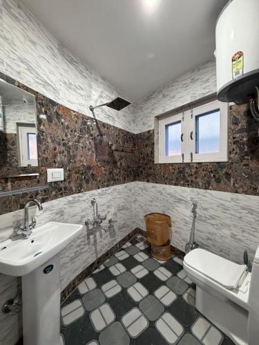 a bathroom with a sink and a toilet at FarahBakshResidency in Jāmb