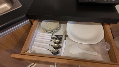 a drawer with some utensils in a kitchen at Ann's Haven in Cebu City