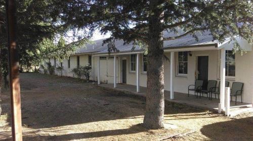 a white house with a tree in front of it at The Historic Railway Barracks in Goulburn