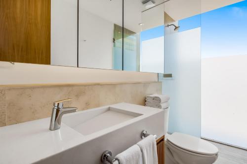 a bathroom with a sink and a toilet at Oceanfront Gem with Bay View Terrace & Direct Sea Access in Cruz de Huanacaxtle