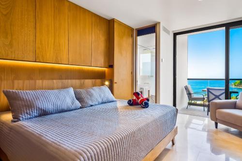 a bedroom with a bed with a toy truck on it at Oceanfront Gem with Bay View Terrace & Direct Sea Access in Cruz de Huanacaxtle