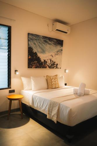 a bedroom with a large bed and a table at Co Day Uluwatu Boutique Stays in Uluwatu
