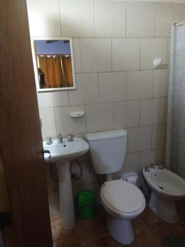 a bathroom with a toilet and a sink at Cabañas de Campo in Villa Unión