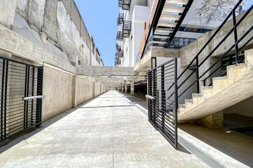 an empty hallway between two buildings with metal gates at Ocean-view condo with infinity pool, rooftop lounge, & private balcony in Bucerías