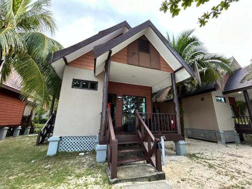 a small house with a staircase in front of it at Tunamaya Beach & Spa Resort Tioman Island in Tioman Island