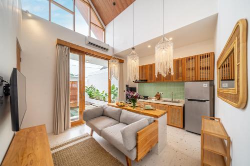 a living room with a couch and a kitchen at Sunset Heaven - Private Pool Cozy Villa with Patio in Kerobokan