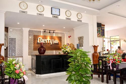 a restaurant with a counter with clocks on the wall at Cherry Villa in Hue