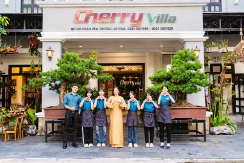 a group of people standing in front of a store at Cherry Villa in Hue