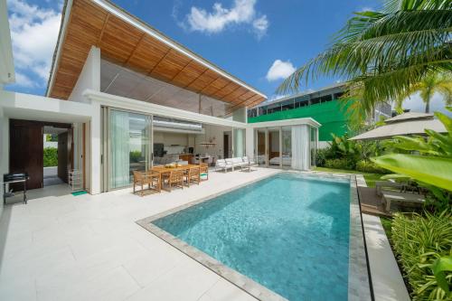 an exterior view of a house with a swimming pool at Luxury villa near Bangtao beach in Phuket