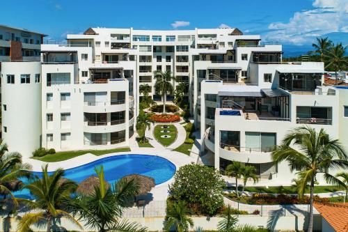 an aerial view of a resort with a swimming pool at Ocean-view condo with resort pool & sundeck in Nuevo Vallarta