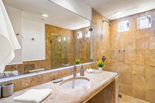 a bathroom with a sink and a shower at Ocean-view condo with private rooftop pool, terrace, & resort-style pool in Nuevo Vallarta