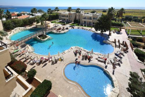 an overhead view of a large swimming pool with people in it at Panareti Coral Bay Villas in Coral Bay