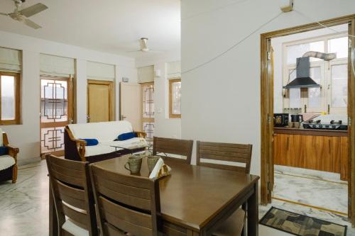 a dining room with a table and a kitchen at Luxury 2 Bedroom's Appartment in Rishīkesh