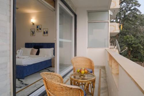 a balcony with a table and chairs and a bed at Luxury 2 Bedroom's Appartment in Rishīkesh