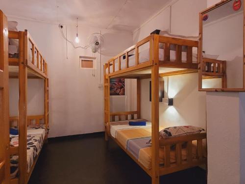 a room with two bunk beds in a room at FMS Rooms & Hostel in Arugam Bay