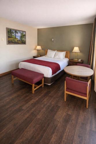a hotel room with a bed and a table at Motel 6 Lake George, NY Adirondacks in Lake George