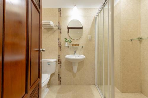 a bathroom with a toilet and a sink and a shower at Hùng Phong Hotel - Near Dalat Market in Da Lat