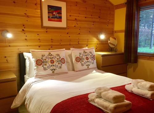 A bed or beds in a room at Rashfield Sheilings - Riverside Lodges, by Pucks Glen, Dunoon