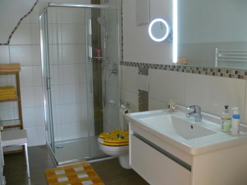 a bathroom with a sink and a shower and a toilet at Gasthof Engel in Bad Wurzach