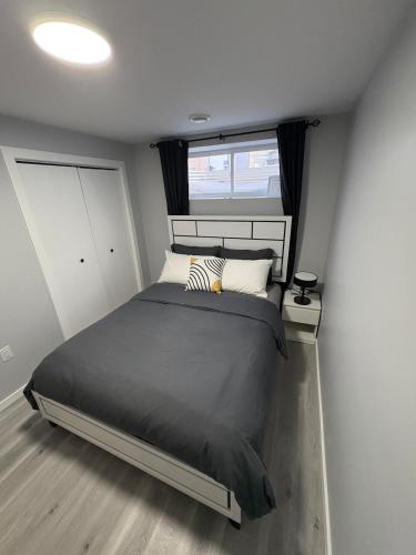 a bedroom with a large bed and a window at Spacious Entire Basement Suite with Free Parking Self Check In in Winnipeg