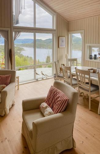 a living room with a couch and a table at Cozy Cabin With Økstrafjord View in Jelsa