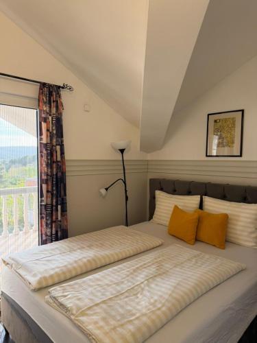 a large bed in a room with a window at Apartmani Tamara in Tivat