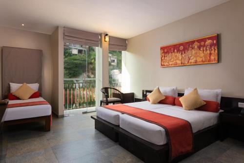 a hotel room with a bed and a window at Oak Ray City Hotel in Kandy