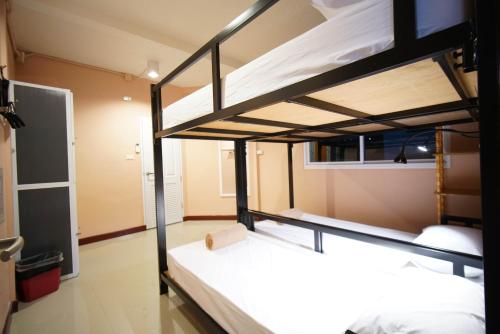 a bedroom with two bunk beds in a room at Urban Hostel Bangkok in Bangkok