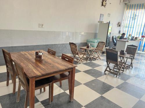 a room with chairs and a table and tables at Ligree Hotel and Restaurant in Jatwāra