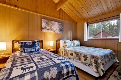a bedroom with two beds and a window at 2583-Bernhardt Brown Bungalow in Big Bear City