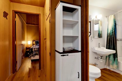 a bathroom with a toilet and a sink at 2583-Bernhardt Brown Bungalow in Big Bear City