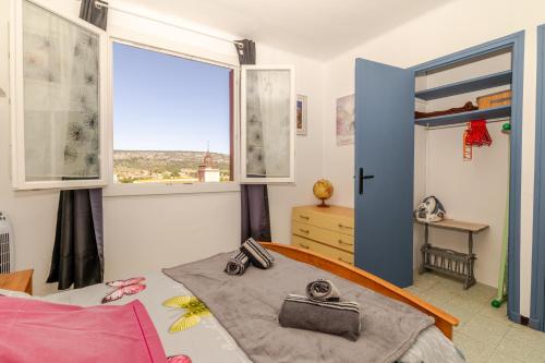 a bedroom with a bed and a window at Appart cathare et l'olivier in Tautavel