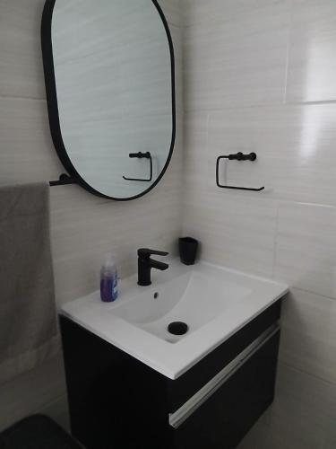a bathroom with a sink and a mirror at Blue Largo Sea View in Westbrook
