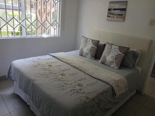 a bed in a bedroom with a window at Blue Largo Sea View in Westbrook