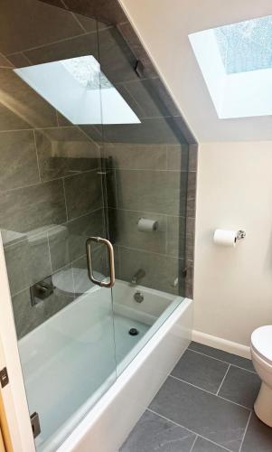 a bathroom with a shower and a bath tub at You Deserve the Best! in Tacoma