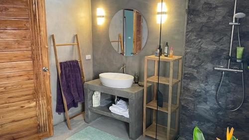 a bathroom with a sink and a mirror at Luxe Sands Pran in Ban Nong Ban Kao