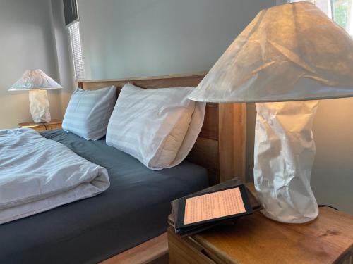 a bedroom with a bed and a lamp on a table at Luxe Sands Pran in Ban Nong Ban Kao
