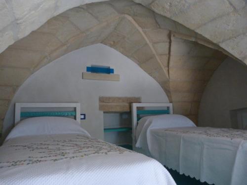 Postel nebo postele na pokoji v ubytování Otranto Vacanza Facile - La Corte