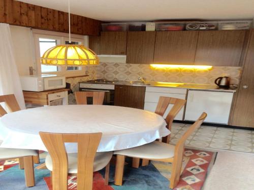 a kitchen with a table and chairs in a kitchen at Apartment in Veysonnaz near Ski Gondola in Veysonnaz