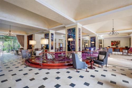 a lobby with chairs and a table in a room at Villa Rosa Kempinski in Nairobi