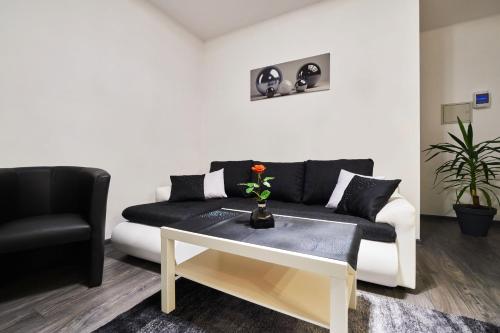 a living room with a couch and a table at Apartament Perła Pienin in Dębno