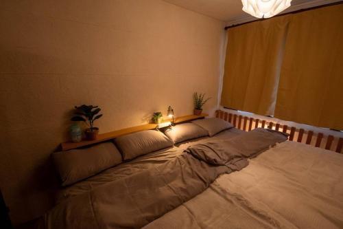 a large bed in a room with a window at SaKuRa B&B in Sakura