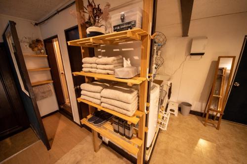 a towel rack with towels on it in a bathroom at SaKuRa B&B in Sakura