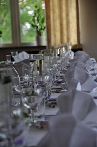 a row of wine glasses on a long table at Sjögestad Motell in Vikingstad